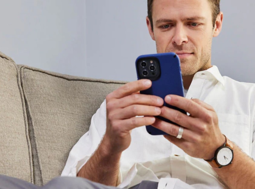 Homem no sofá a olhar para o telemóvel